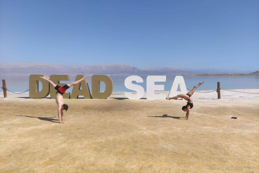 Two students doing gymnastics at the Dead Sea