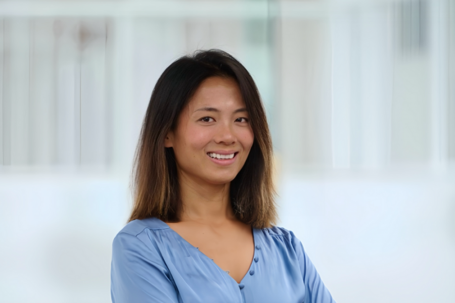 Image of woman professor smiling in a blue top. 