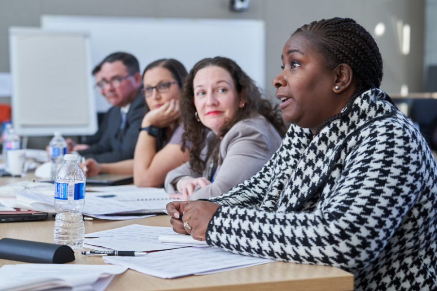 Image of various business people commenting on a presentation.