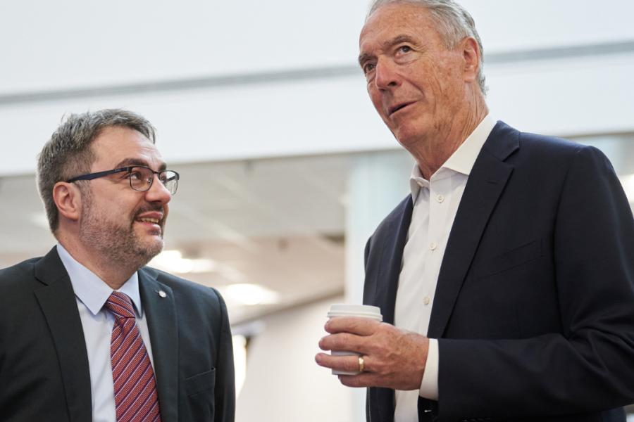 Two men talking in business suits.