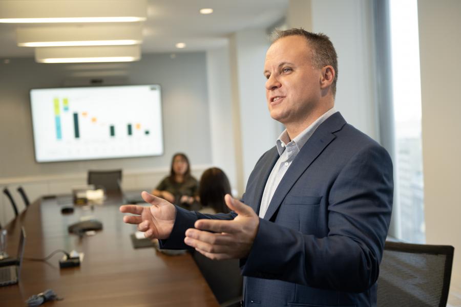 man presenting in front of screen