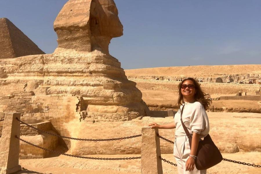 Young woman standing in front of the Sphinx