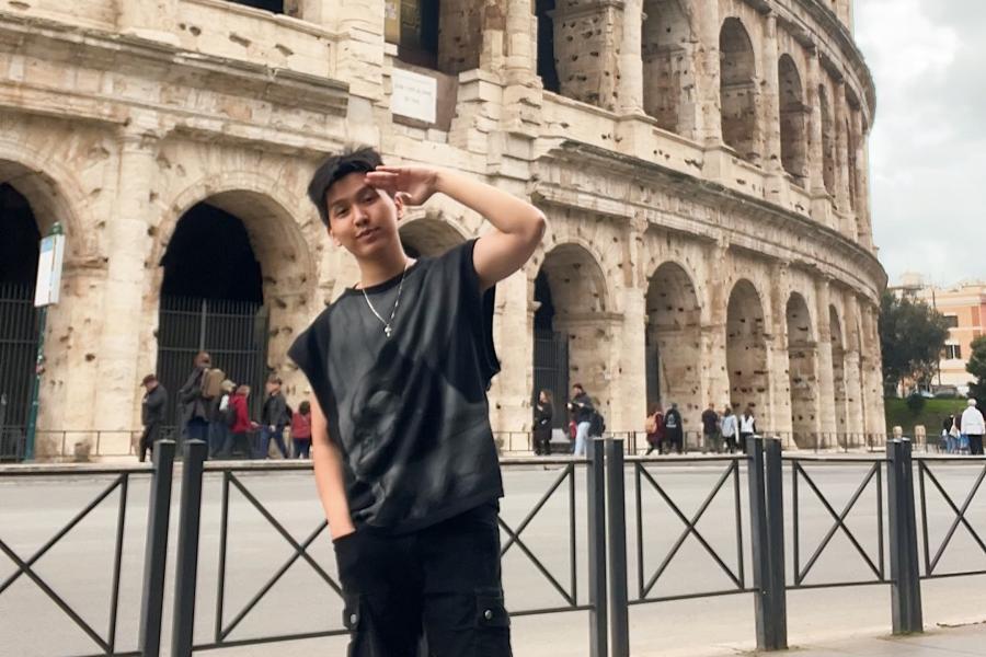 Young man standing in front of the Colisseum