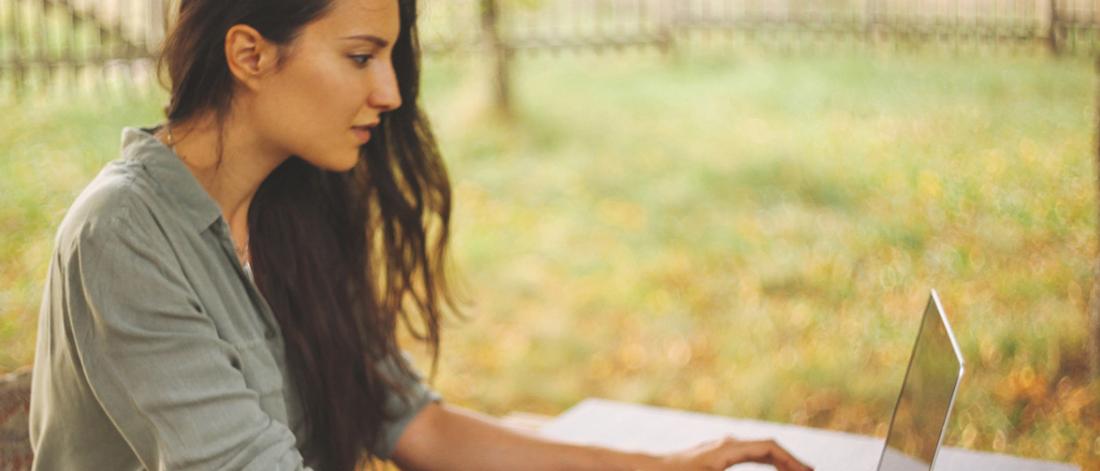 Student doing assignments outside.