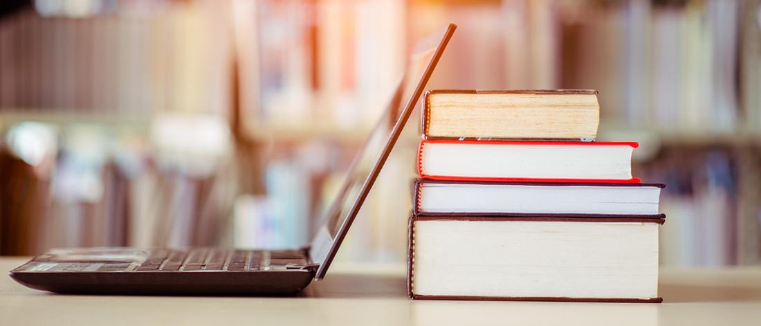 Books and laptop in library.