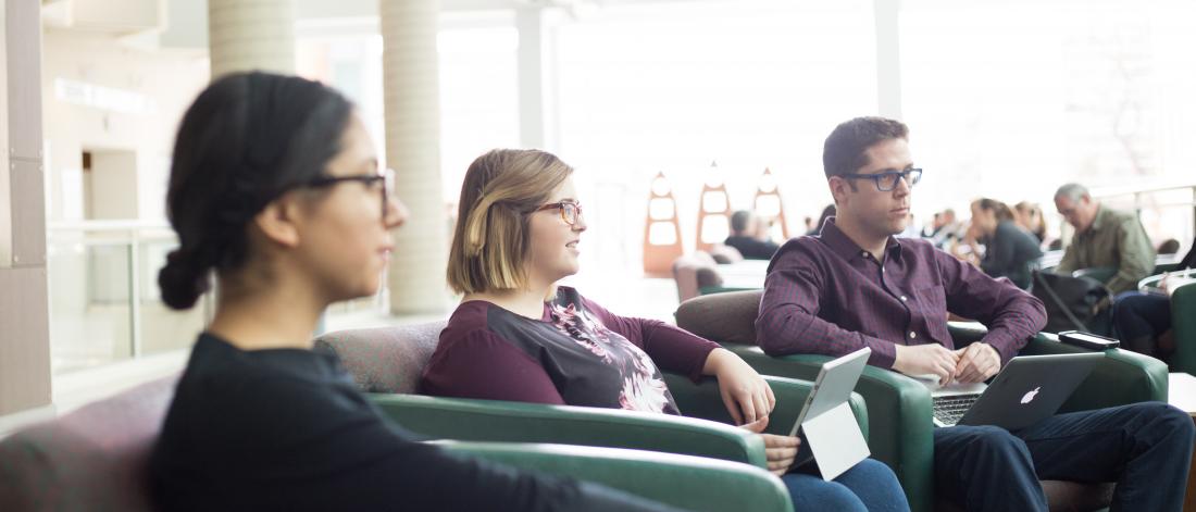 Student listening in the Brodie Atrium on UM campus.