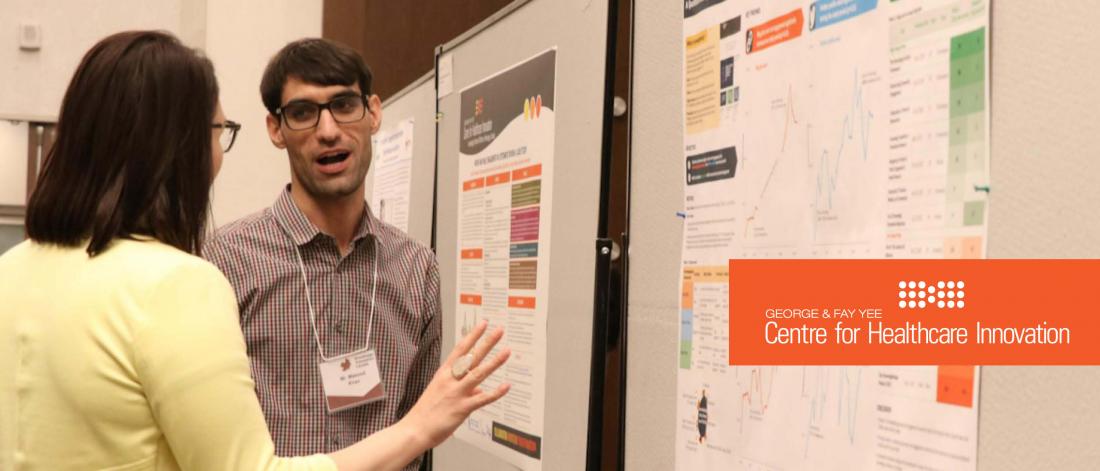 Two people looking at a research poster.
