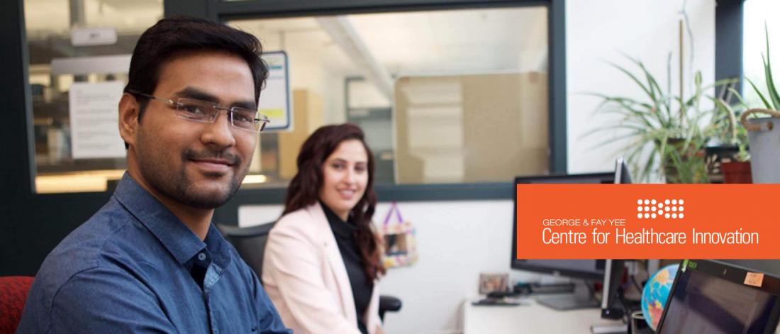 Two graduate students smiling at the camera.