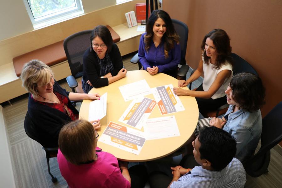 Group of staff sitting at a round table.