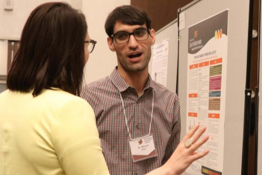 Two people looking at research posters.