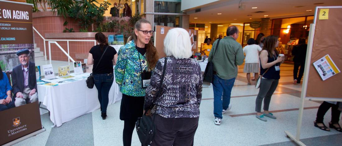 Centre on Aging Director connects with a community member at the Spring Research Symposium.