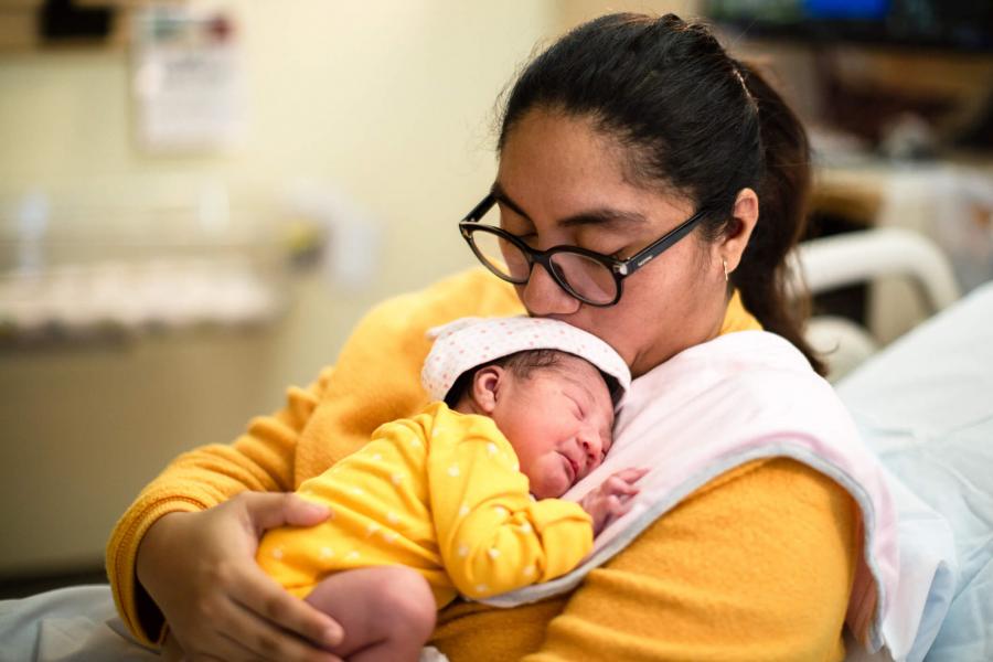 Mother holding a preemie baby.