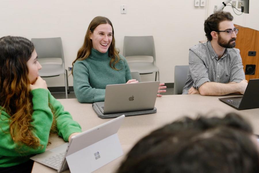 students sitting with their lap tops open.