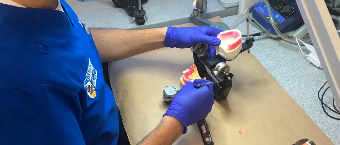 A restorative dentistry student works on a project. 