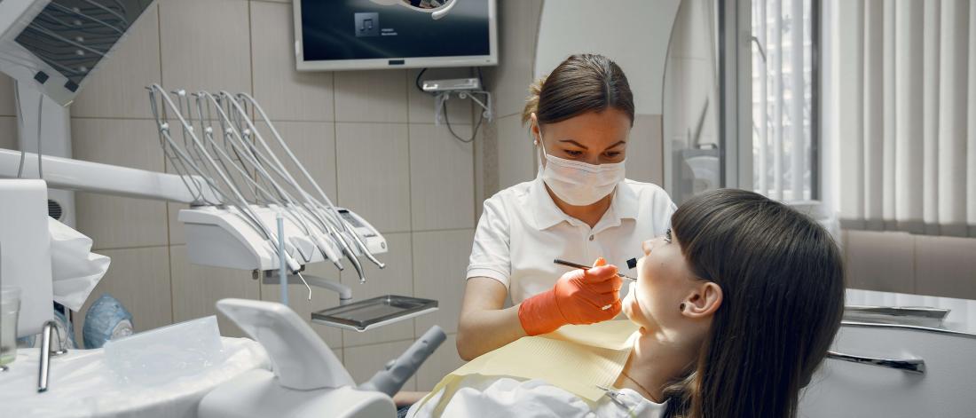 Patient having her teeth examined.