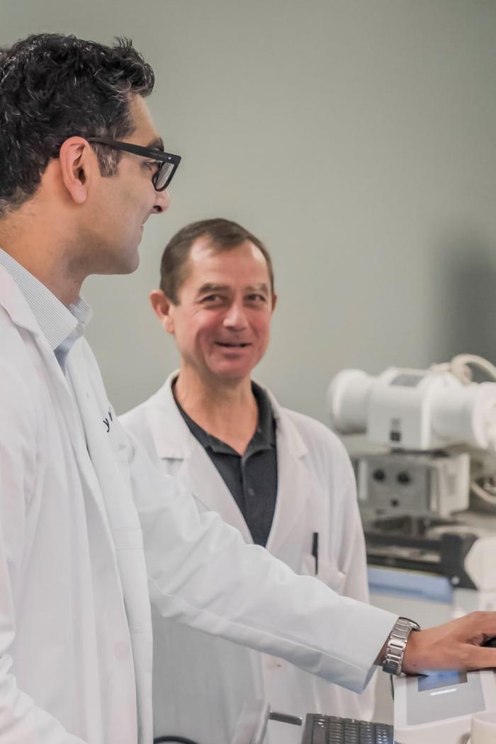 Scientists reviewing a computer screen.