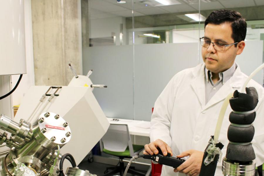 Researcher demonstrating specialized lab equipment.