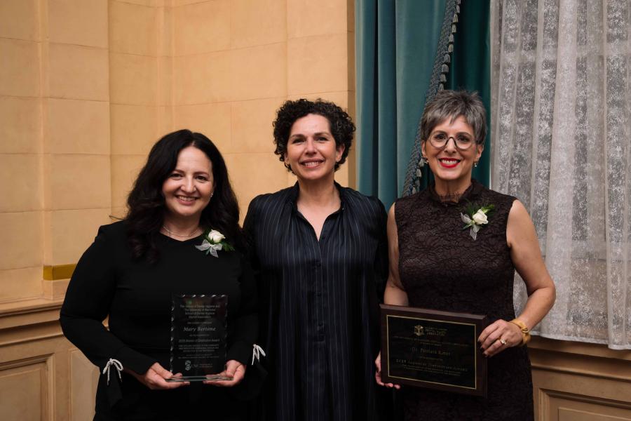 Three people in formal wear pose for photo. 