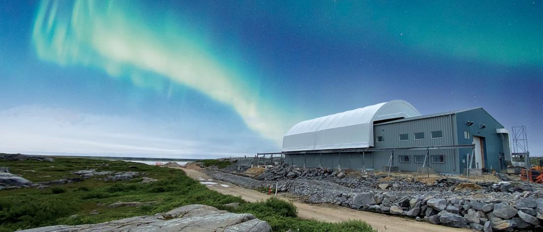 Outside view of the Churchill Marine Observatory with the northern lights, or aurora borealis, in the sky