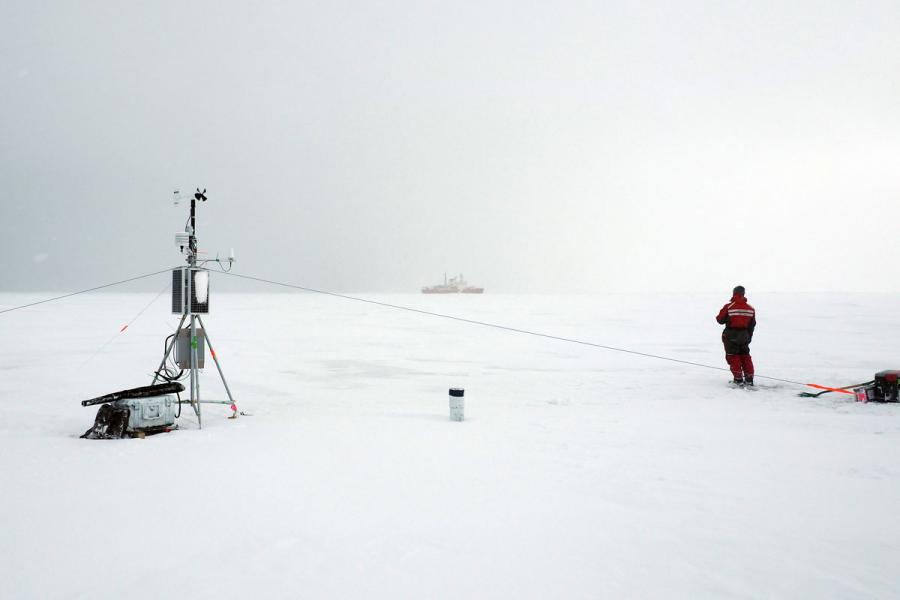 A researcher stands on an ice tower.