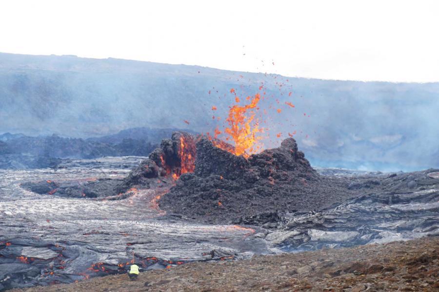 a researcher retrieves equipment threatened by rising tide of lava.