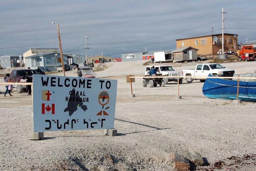 'Welcome to Coral Harbour' sign.