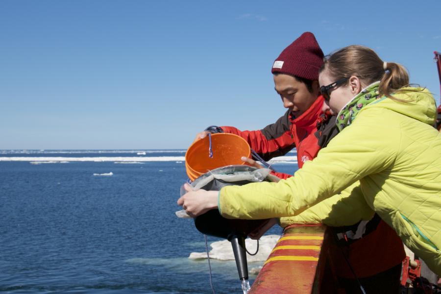 Students conducting field work on a boat