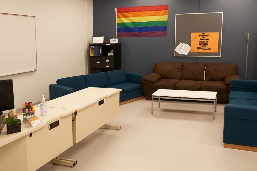 Interior of the Faculty of Education Student Association office with a desk and computer work station and lounge area. 