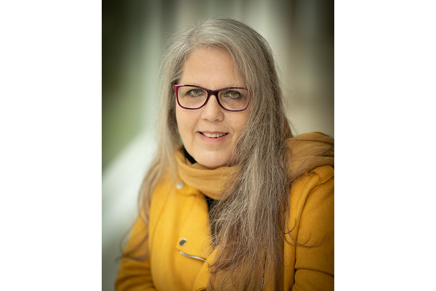 Sandra Kouritzin with long hair and yellow shirt 