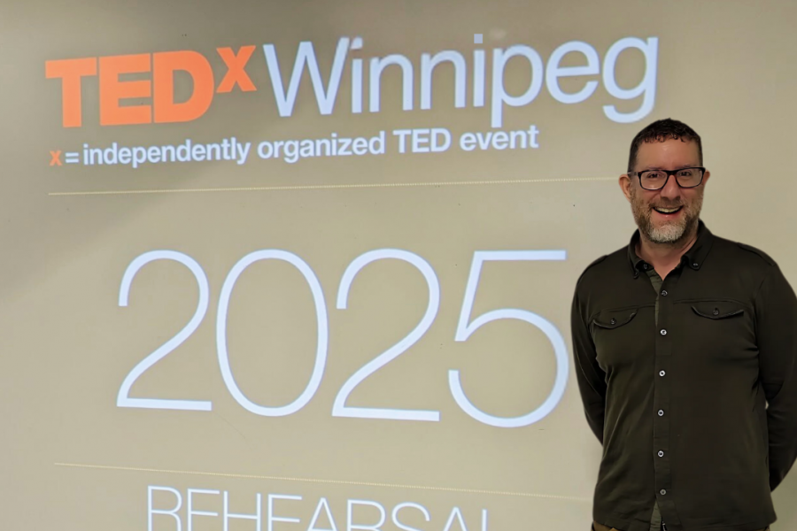 robert mizzi standing next to tedx sign
