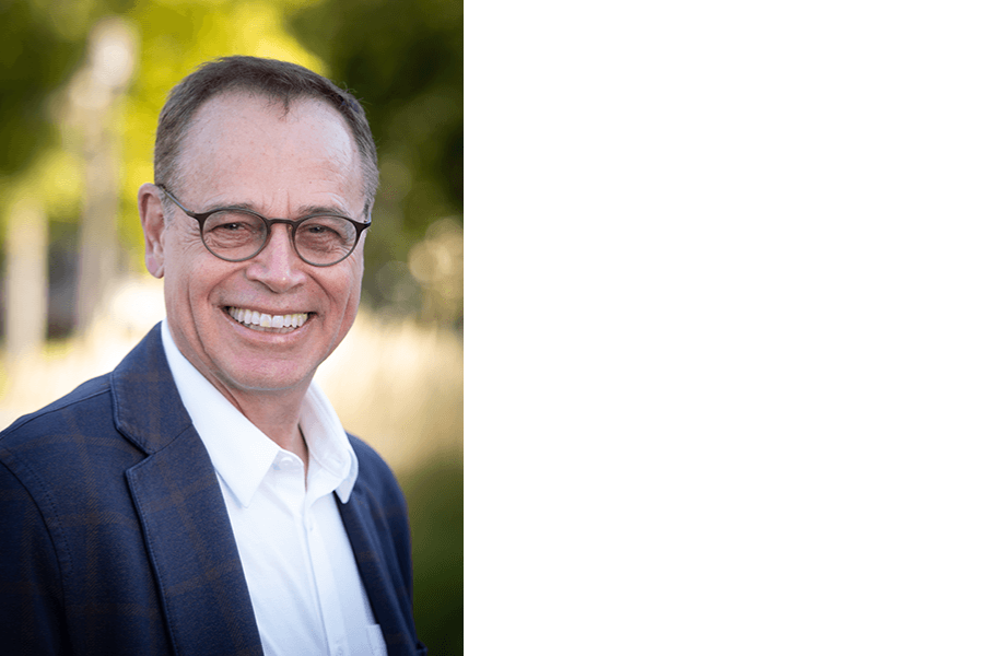 head shot man brown hair and glasses