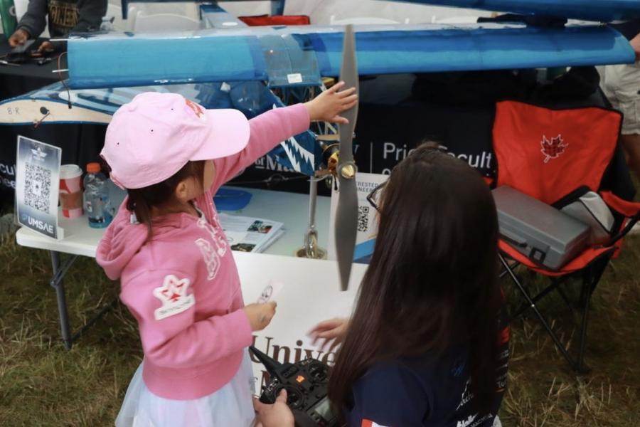 Little kids touching a propeller 