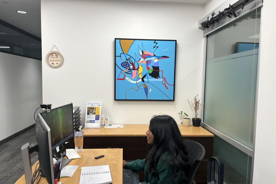 Girl sitting in front of Ombaashi painting
