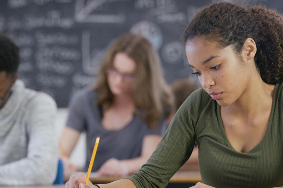 Young adults taking a test.