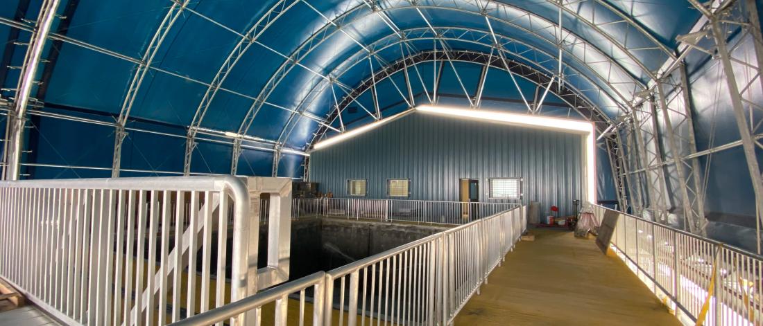 The interior of the Churchill Marine Observatory, an open space with guardrails and a blue ceiling.