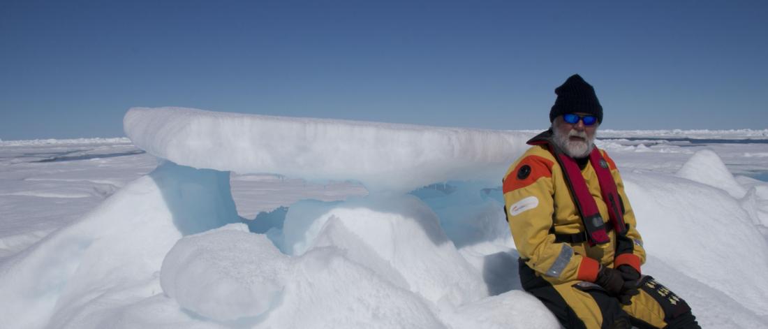 Doctor david barbour sitting on some snow in the arctic.