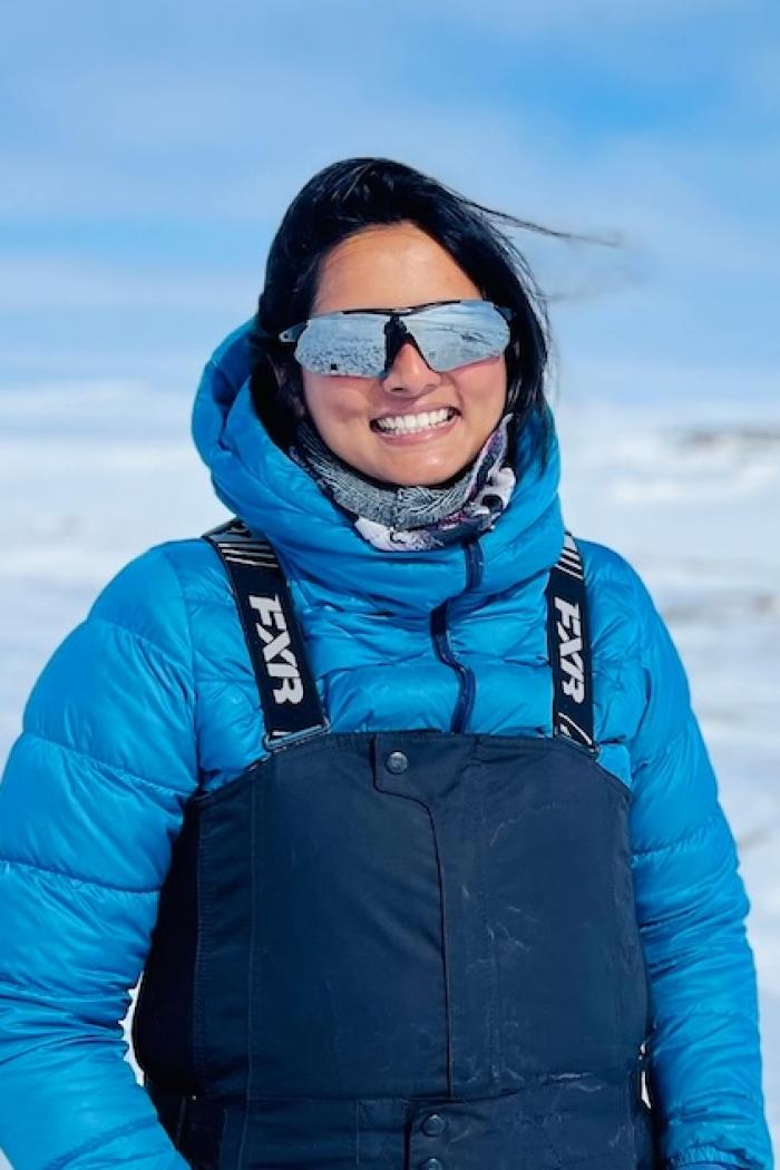 Fowzia Ahmed smiles on the ice in her arctic gear
