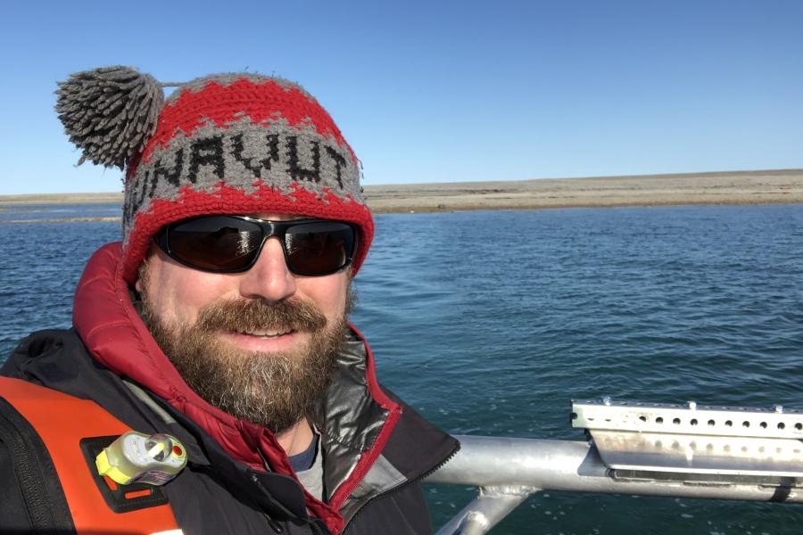 Doctor cj mundy posing outdoors in red toque and parka.