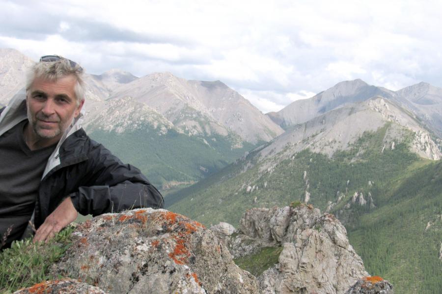  Anton r. chakhmouradian outdoors leaning on rocks.