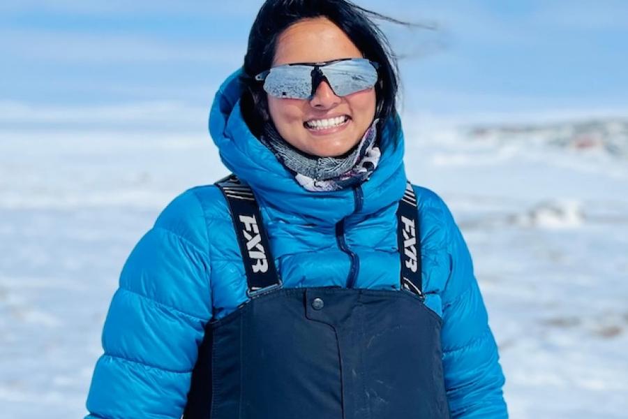 Fowzia Ahmed smiles on the ice in her arctic gear