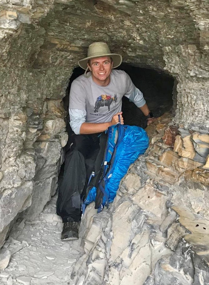 Tim hayward climbing in the rocks while hiking.