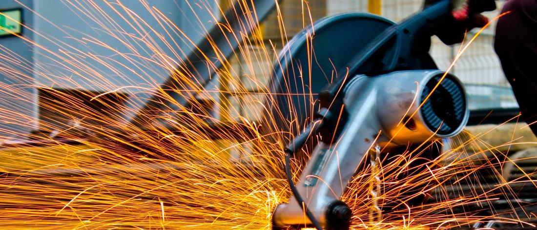 Sparks flying from saw.