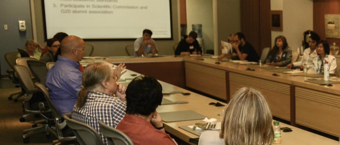 People sitting around conference table.