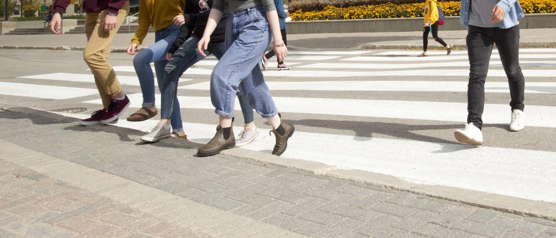People crossing the road on crosswalk.
