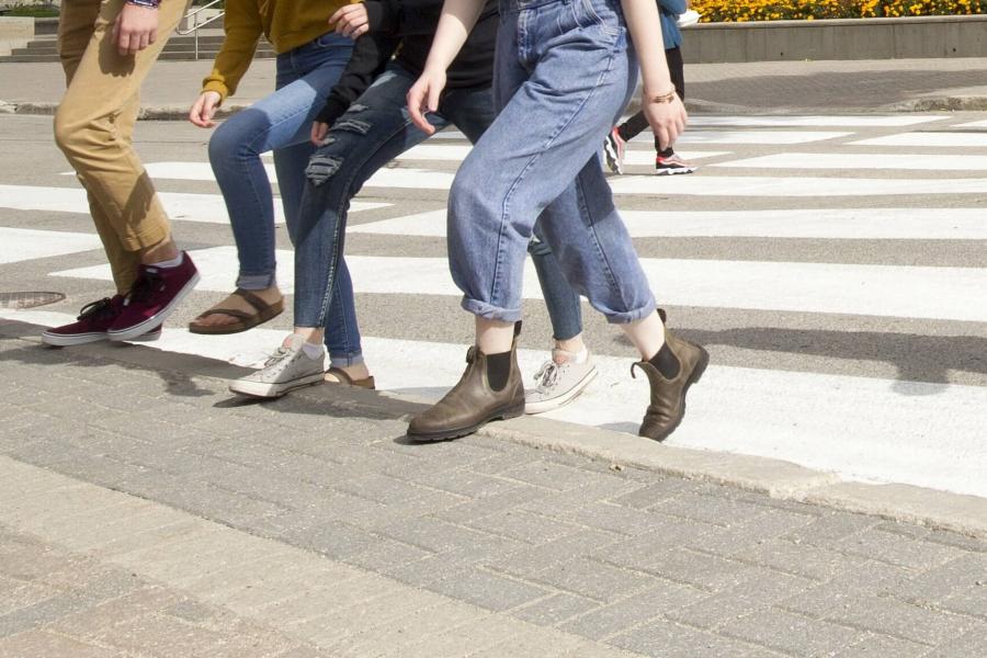 People crossing the road on crosswalk. 