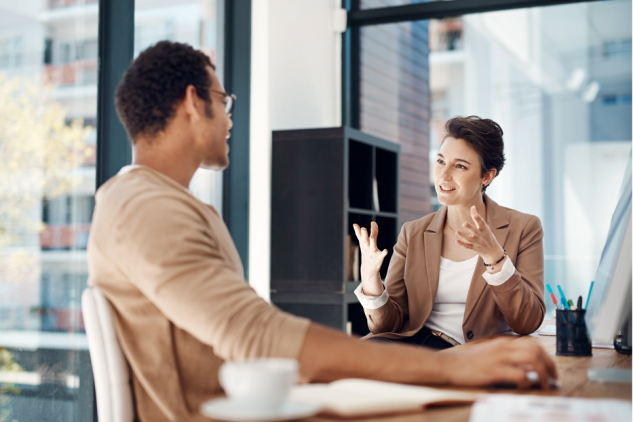 Woman coaching man in office setting