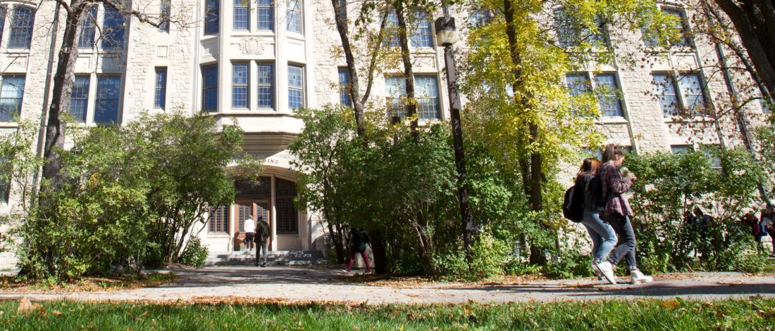  Students walking past the Tier building on the University of Manitoba Fort Garry campus.