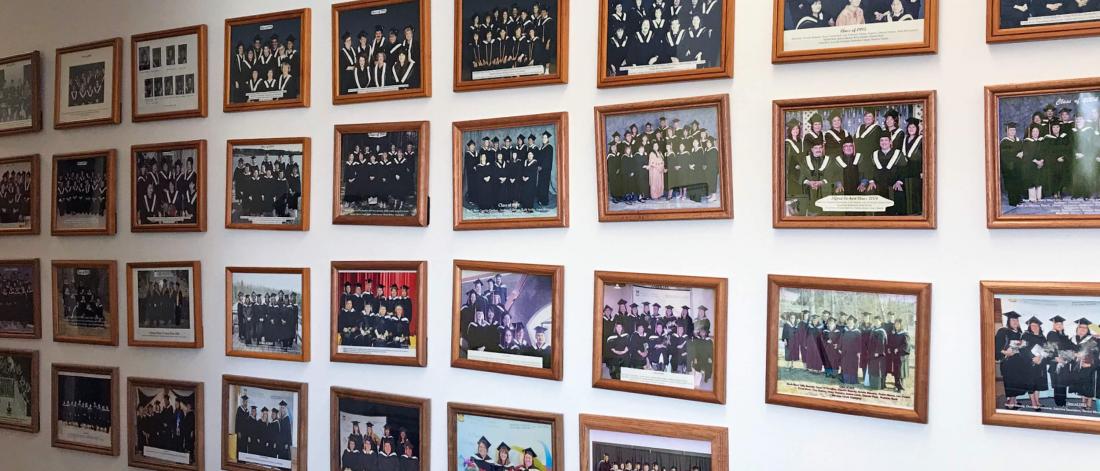 The Northern Social Work wall of fame lined with rows of graduate student photos.