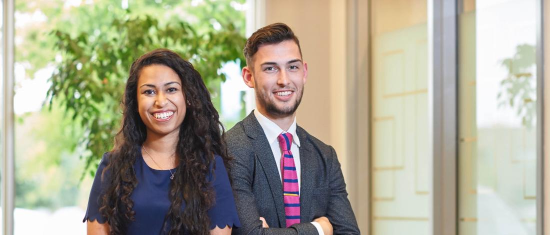 Two Asper Accounting bachelor of commerce students stand side by side.