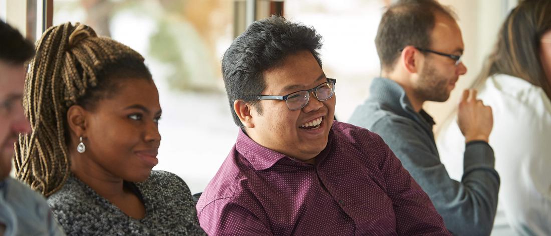 Students smile during a networking event.